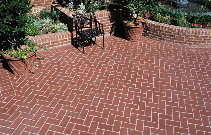 Available in patterns such as running bond, herringbone, and basket weave, brick flooring adds texture and character while offering a long-lasting, low-maintenance surface for brick entryways.